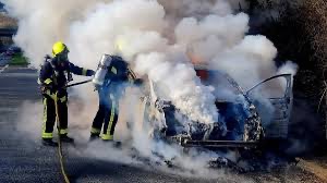 Firefighters extinguishing a vehicle fire